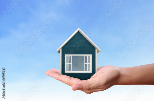 Mortgage concept by house  in hand