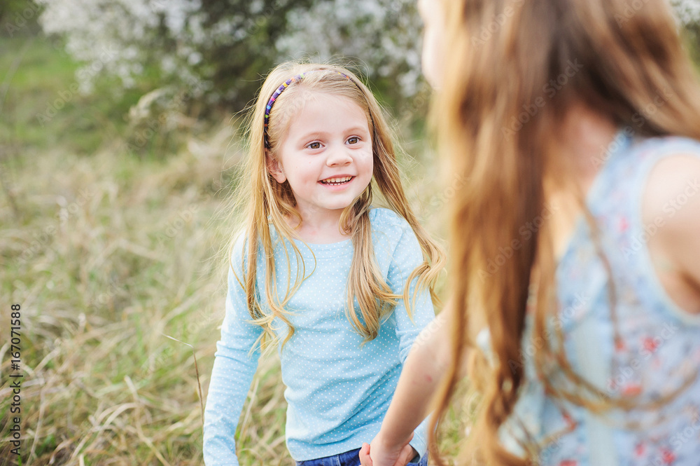 Sisters walk in the garden of flowering trees
Sisters walk in the garden of flowering trees