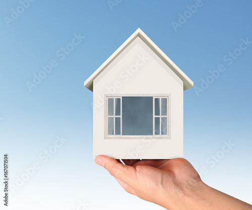 Mortgage concept by house in hand