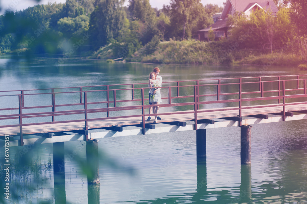 Obraz premium A romantic date, the couple on the bridge and a bouquet of flowers