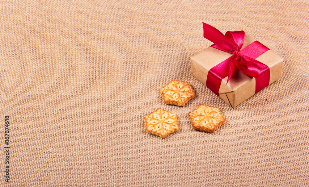Christmas cookies in the form of snowflakes and a gift box. Festive concept. New Year's and Christmas. Copy space Christmas cookies in the form of snowflakes and a gift box. Festive concept. New Year's and Christmas. Copy space