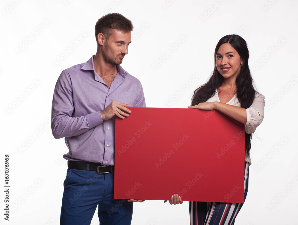 Young happy woman portrait of a confident businesswoman showing presentation, pointing placard gray background. Ideal for banners, registration forms, presentation, landings, presenting concept. Young happy woman portrait of a confident businesswoman showing presentation, pointing placard gray background. Ideal for banners, registration forms, presentation, landings, presenting concept.