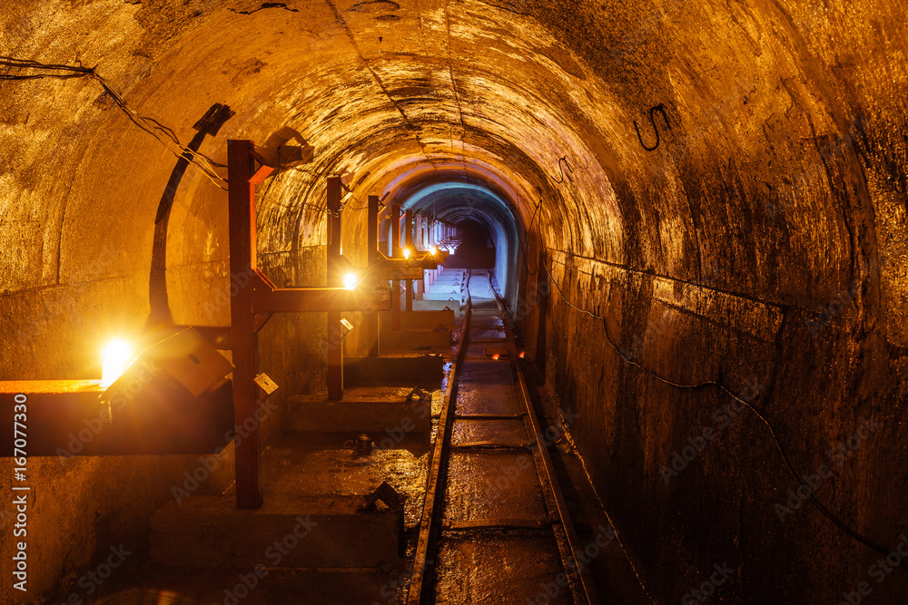 Fototapeta premium Round underground technical tunnel with a narrow-gauge railway