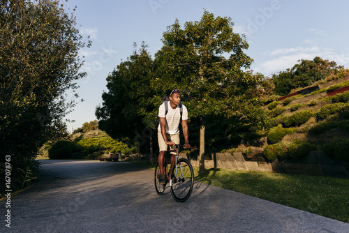 Wallpaper Mural Young man riding bike on pavement Torontodigital.ca