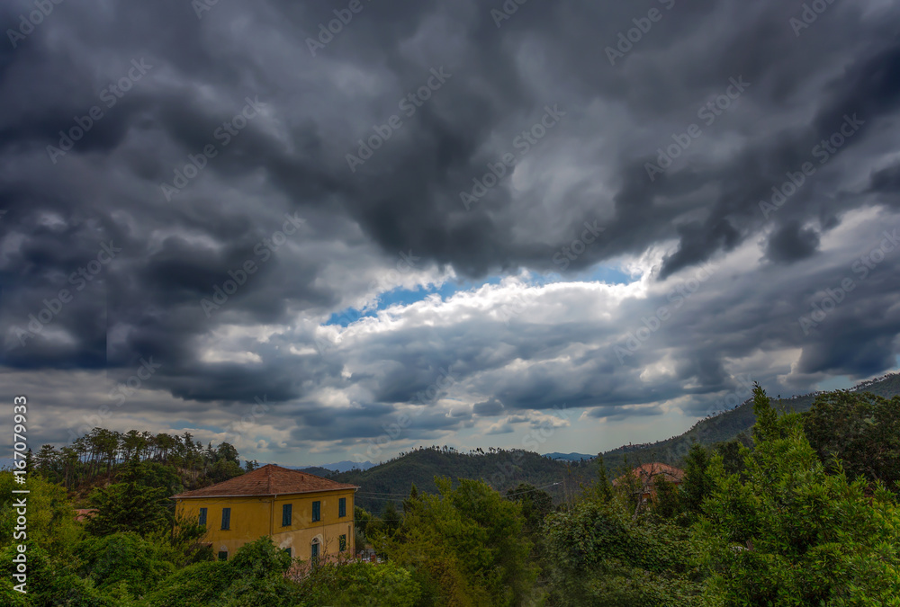 Isolated house in the countryside under a very cloudy sky Isolated house in the countryside under a very cloudy sky