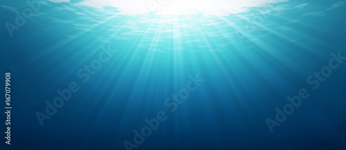 Obraz na plátně Underwater blue sea background photo with with sun and sunlight shining under the sea