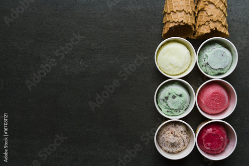 Top view of Ice cream flavors in cup and topping, sweet and dessert food concept