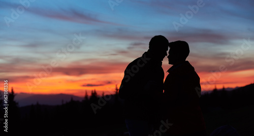 Close-up silhouettes of a loving couple of hikers kissing on top of the mountain copyspace love anniversary achieving togetherness affection romantic hiking active © anatoliy_gleb