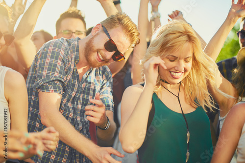 Group of people dancing and having good time at music festival