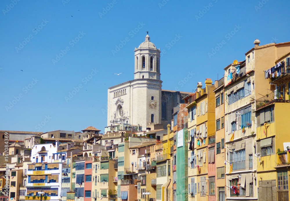 Hanging houses from the river in an spanish oldtown with a cathedral on the background