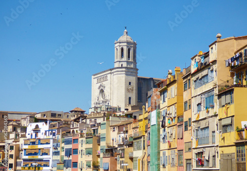 Hanging houses from the river in an spanish oldtown with a cathedral on the background