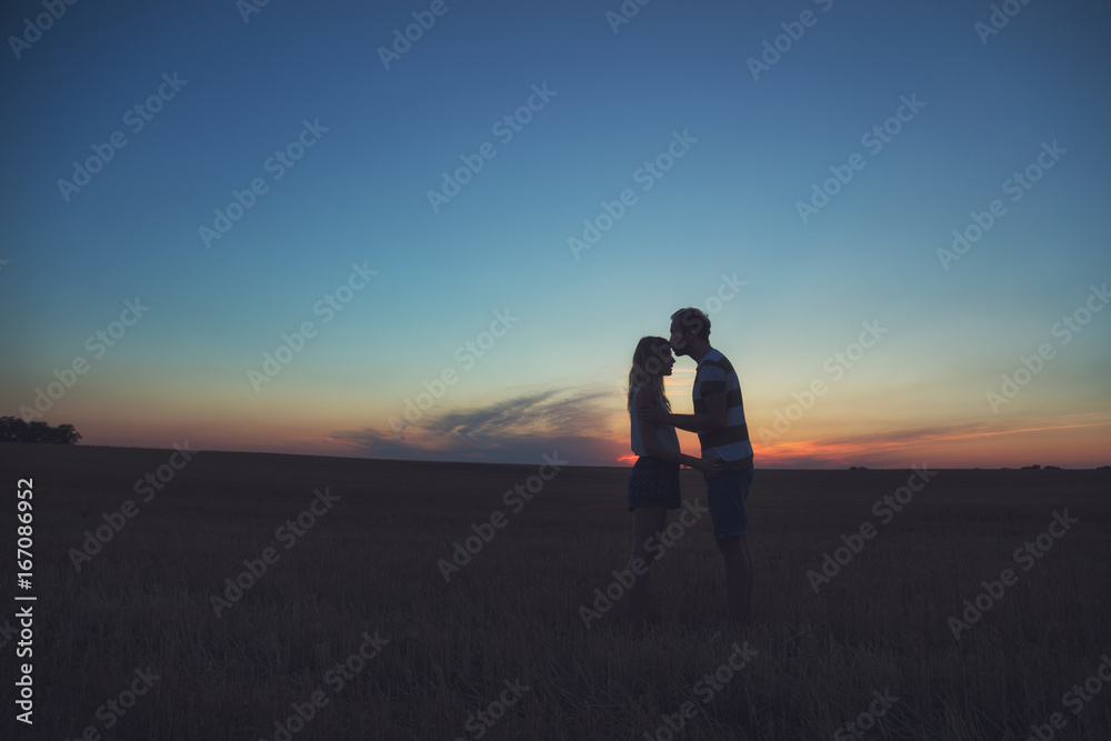 Young couple enjoying outdoors in the field.