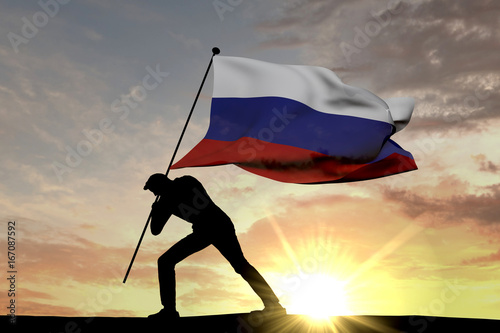 Russia flag being pushed into the ground by a male silhouette. 3D Rendering