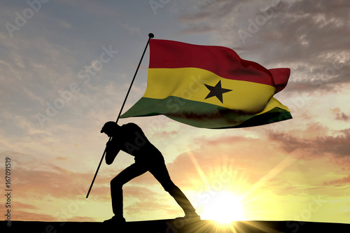 Ghana flag being pushed into the ground by a male silhouette. 3D Rendering