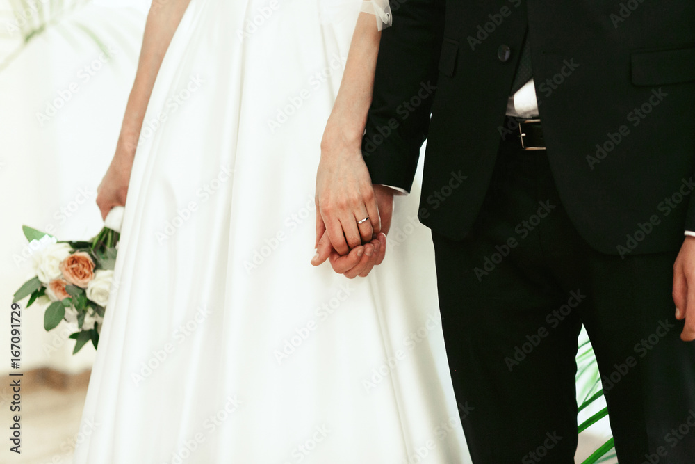 Bride and groom hold each other hands tender Bride and groom hold each other hands tender