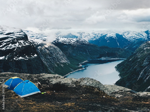 Two blue tents stand before a gorgeous mountain view