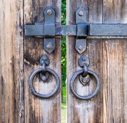 wooden gates with iron knobs. background, exterior