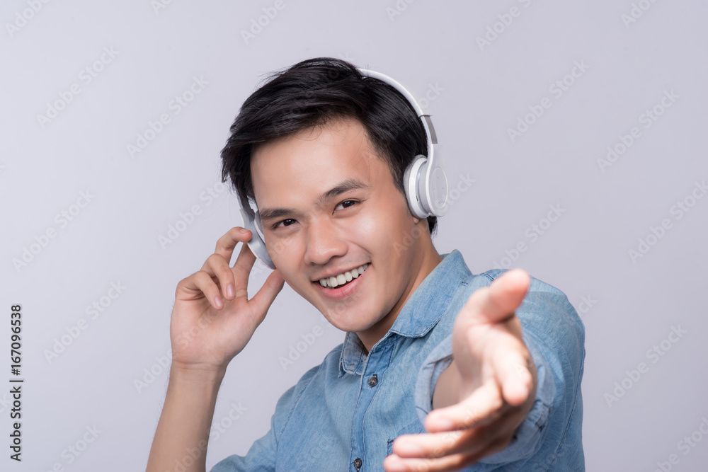 Smart casual asian man with headphone in studio background Smart casual asian man with headphone in studio background