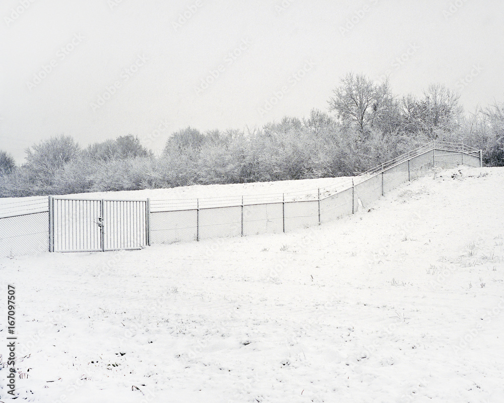 A fence in the snowy landscape during winter