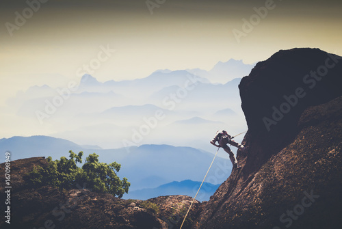 Climber against mountain valley. Instagram stylization