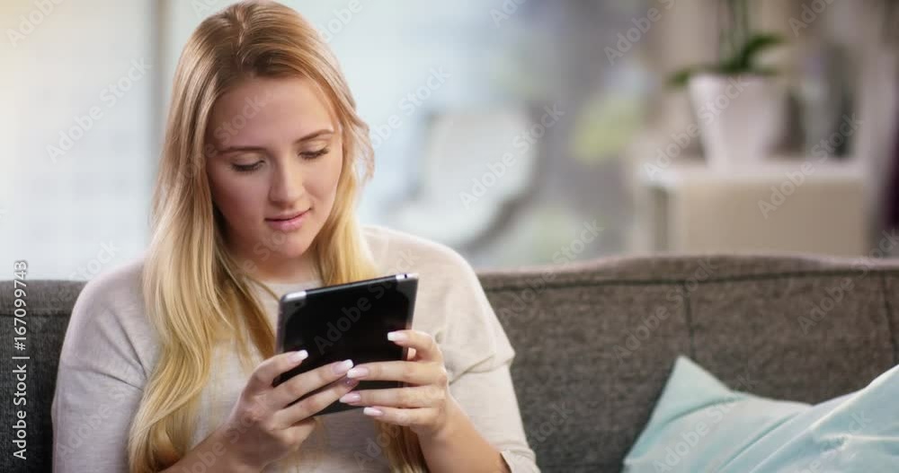 Young woman doing something on a tablet Young woman doing something on a tablet