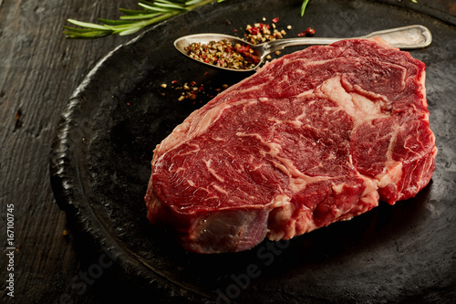 Slice of raw steak on plate