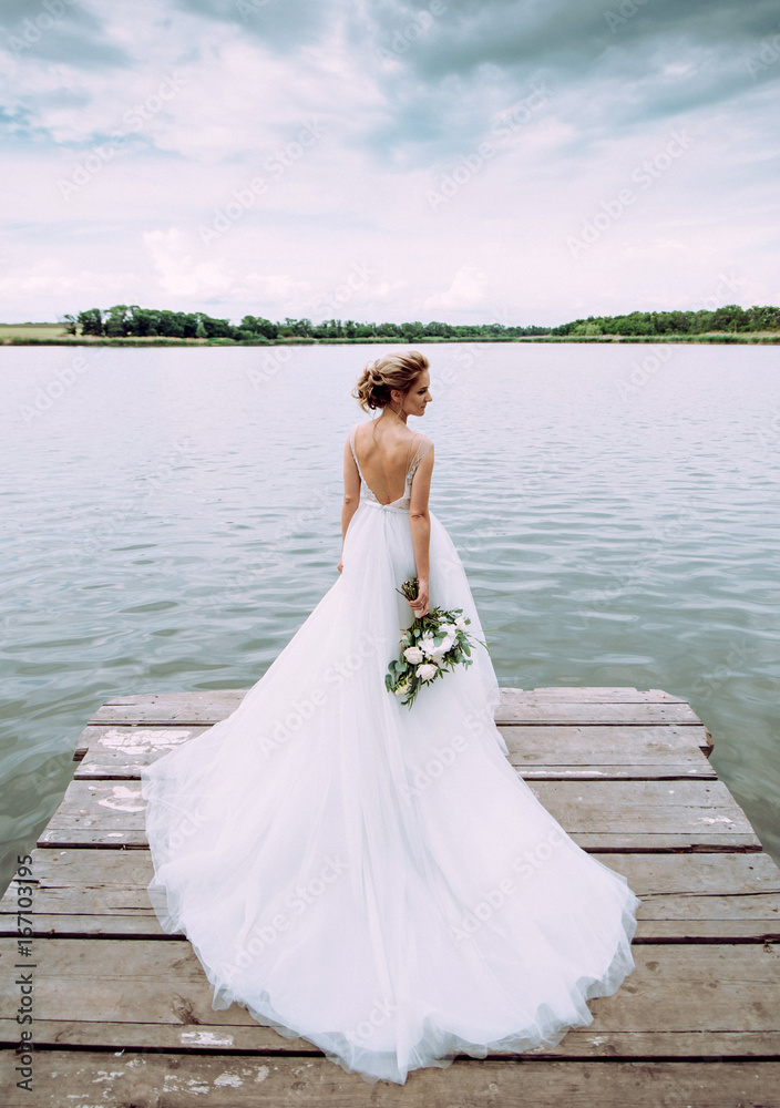 Beautiful bride in the nature in a luxurious dress Beautiful bride in the nature in a luxurious dress