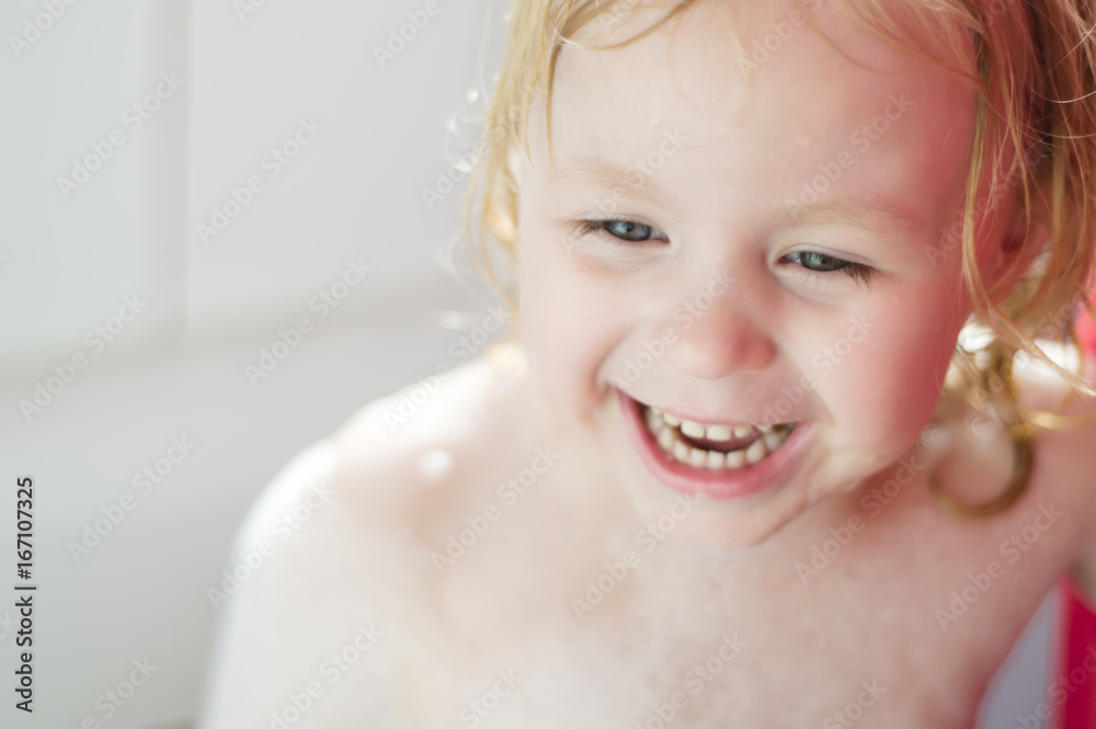 Children in the bathroom,Child taking bath. . Kids playing with foam and water splashes. White bathroom with window. Children hygiene. Children in the bathroom,Child taking bath. . Kids playing with foam and water splashes. White bathroom with window. Children hygiene.