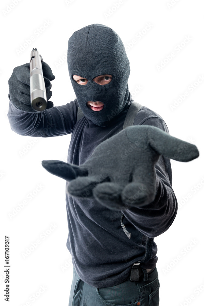 Armed robber requires money and aims at the camera Armed robber requires money and aims at the camera