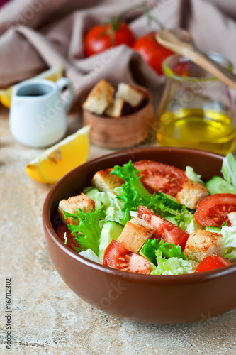 Vitamin salad with vegetables and lemon juice on a concrete background