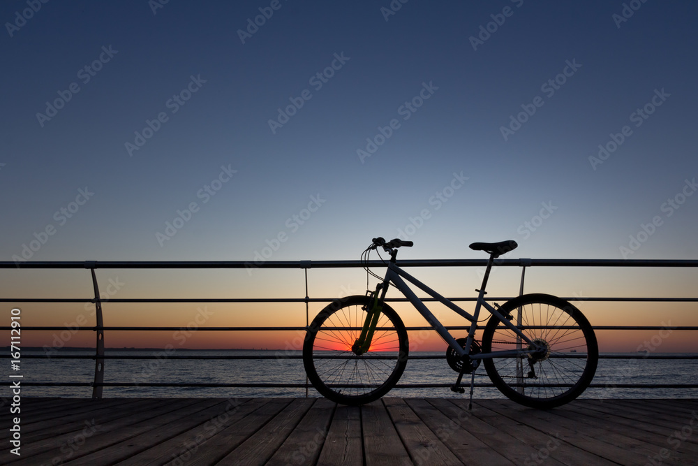 Silhouette of a parts bicycle, handlebar on the beach Silhouette of a parts bicycle, handlebar on the beach