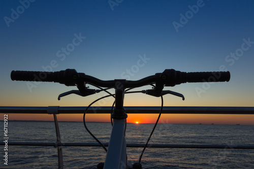Silhouette of a parts bicycle, handlebar on the beach 