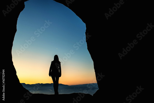 Female traveler in mountains at night