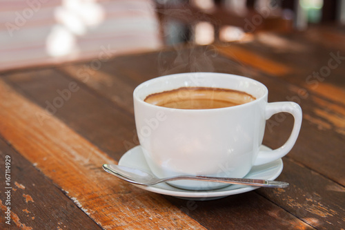 Hot espresso coffee on wooden table