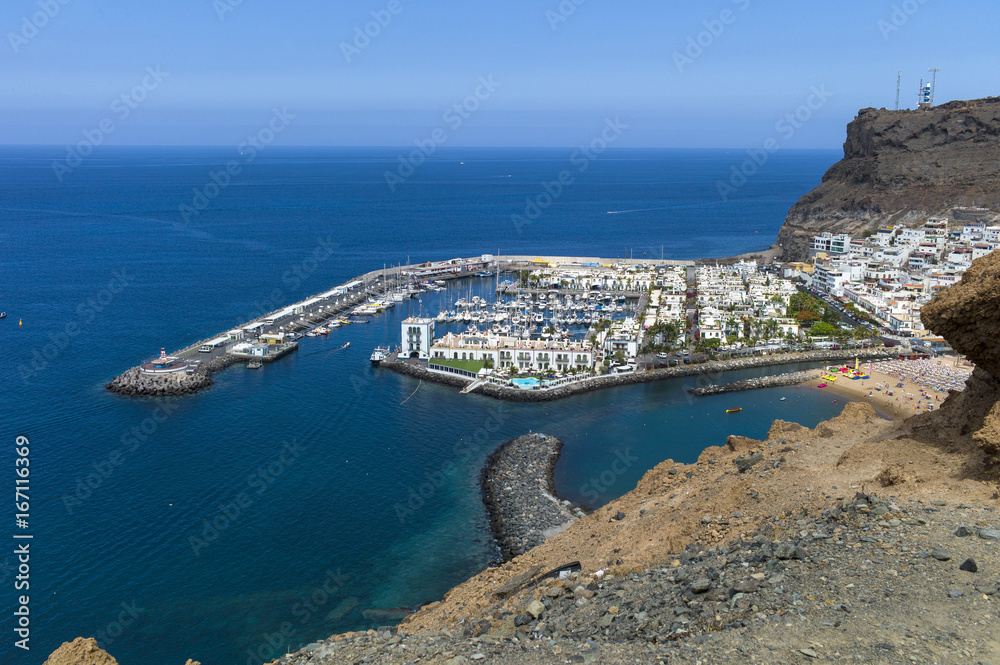 Old town, harbor of historic town Mogan Gran Canaria at perfect sunny weather with blue skies in the morning.