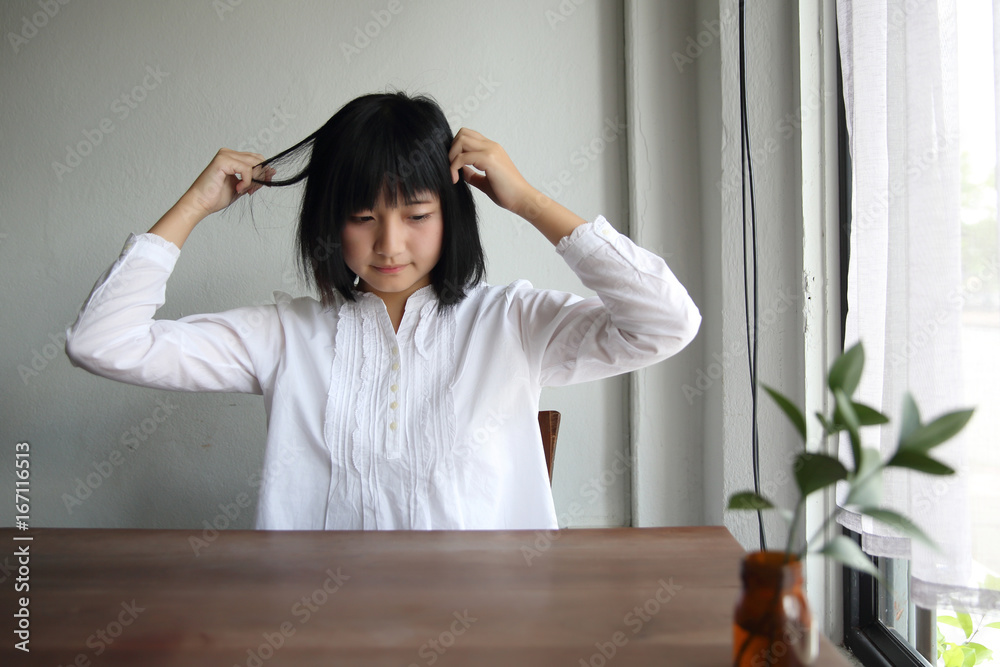 Asian young woman thinking and looking portrait in coffee shop cafe Asian young woman thinking and looking portrait in coffee shop cafe