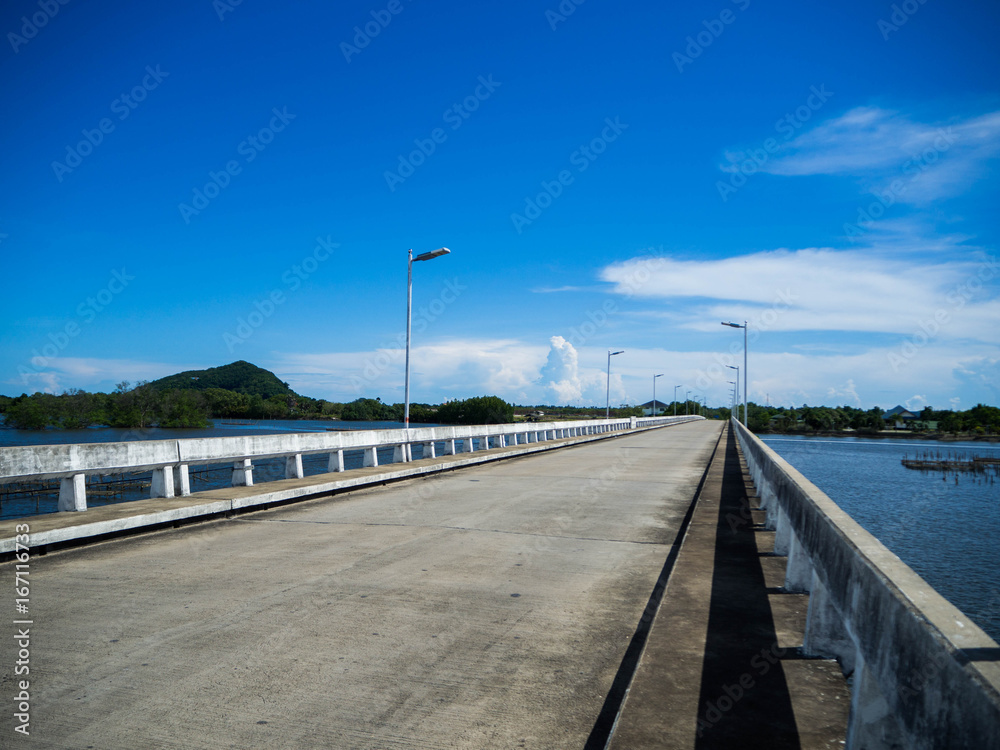 River bridge One day in the blue sky. The left is a green mountain. And blue water on the side.