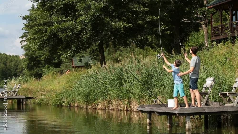 Cute teenager learning to fish on lake in summer Cute teenager learning to fish on lake in summer