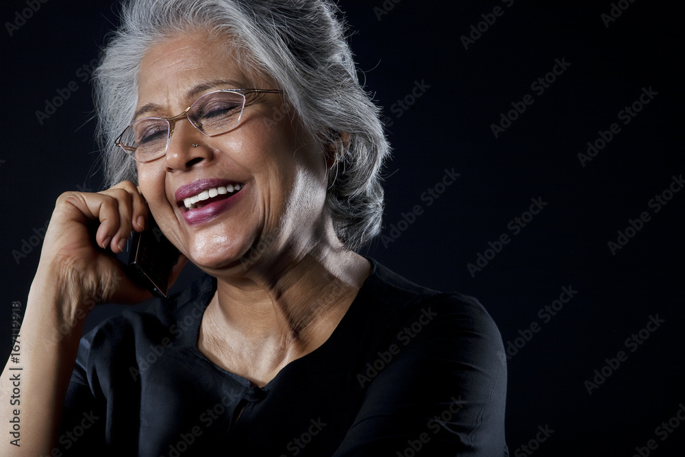 Old woman talking on a mobile phone Old woman talking on a mobile phone