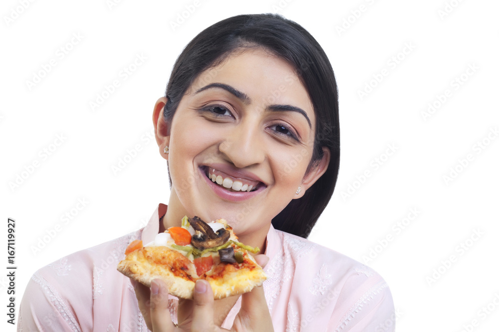 Close-up of smiling young woman holding slice of pizza 