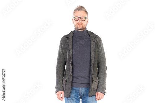 Studio portrait of middle aged man wearing casual clothing and eyeglasses