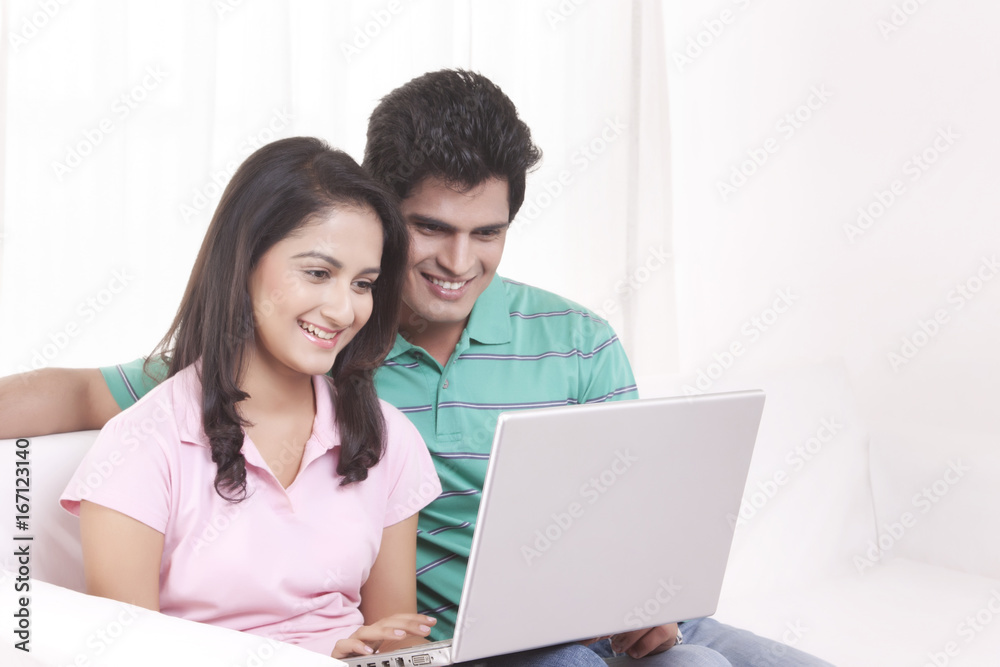 Young man and woman working on the laptop