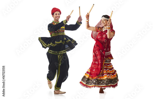 Couple performing dandia dance 