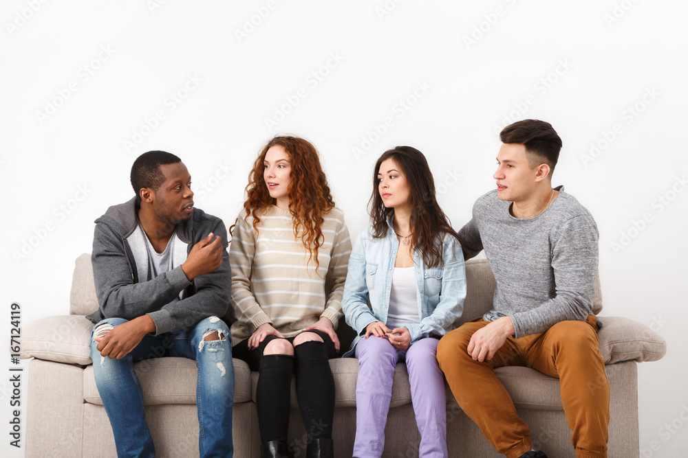 Happy young friends, casual people sitting on couch Happy young friends, casual people sitting on couch