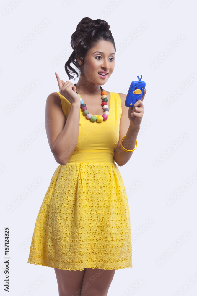 Young woman reading sms on mobile phone Young woman reading sms on mobile phone