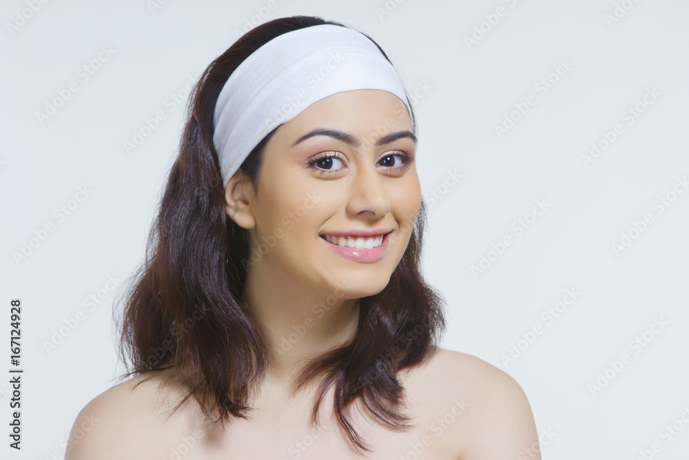 Portrait of beautiful woman wearing headband against white background Portrait of beautiful woman wearing headband against white background