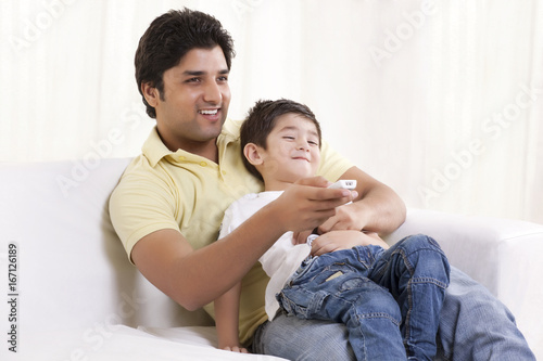 Happy father and son watching television  © IndiaPix