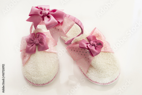 Fototapeta Naklejka Na Ścianę i Meble -  Pair of blank white home slippers and ornate coronet. Bed shoes accessory footwear