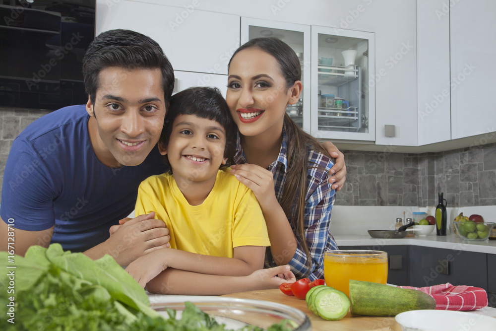 Portrait of parents with son in the kitchen
