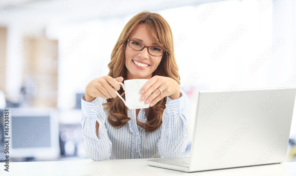 Morning coffee. Shot of a beautiful businesswoman having coffee in the office. 